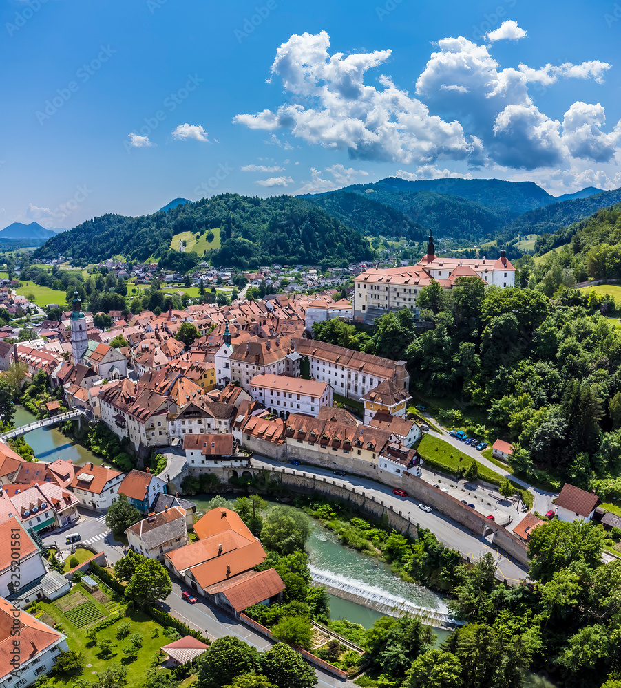 An aerial view across the Selca Sora river and the old town in Skofja Loka, Slovenia in summertime
