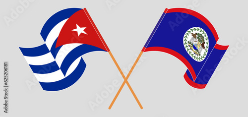Crossed and waving flags of Cuba and Belize