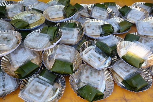Bugis cakes wrapped in banana leaves and gandus cakes wrapped in plastic as menus for wedding receptions in the village. photo