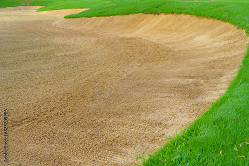 Golf Course Sand Pit Bunkers, green grass surrounding the beautiful sand holes is one of the most challenging obstacles for golfers and adds to the beauty of the golf course.