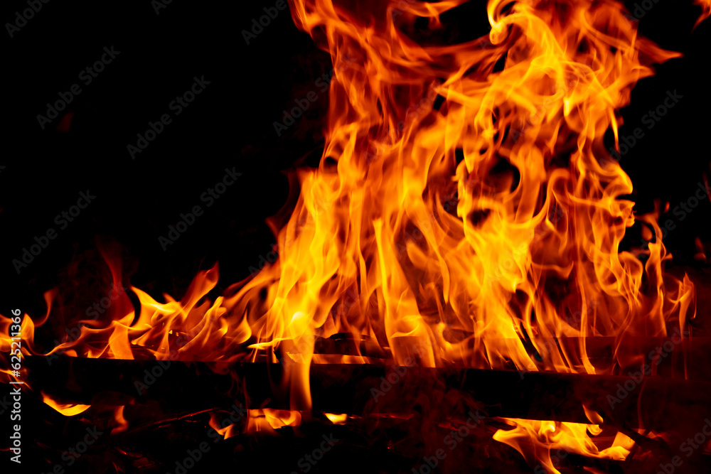 Fire flame burning and glowing on dark black background Fire flame burning and glowing on dark black background