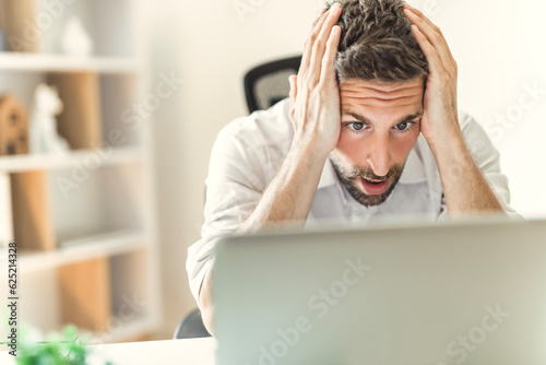 Mature business man using laptop computer in office look like frustrated