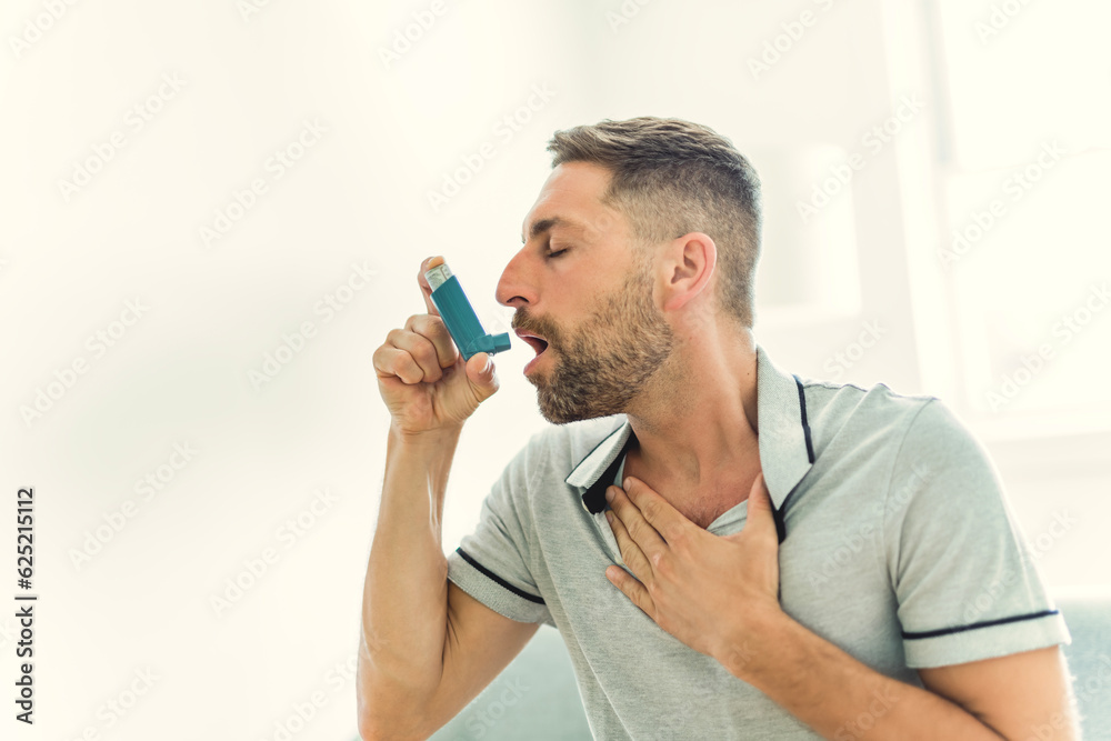 man using asthma inhaler at home man using asthma inhaler at home