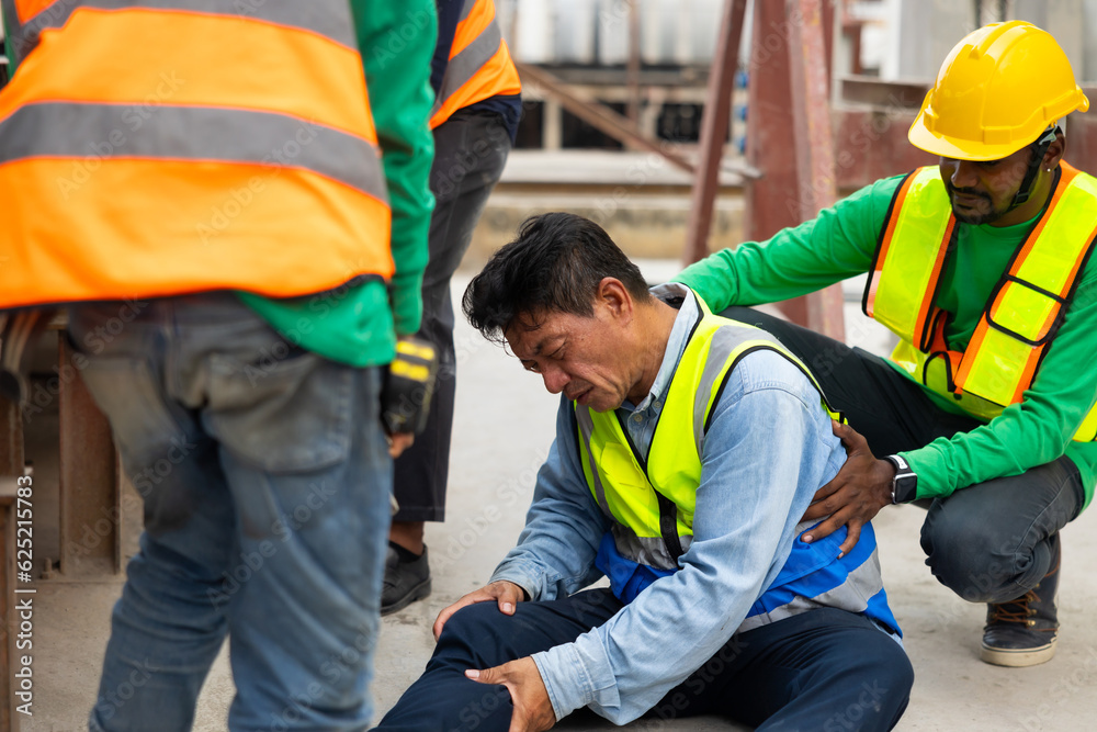 First Aid and safety first concept. Professional engineering teamwork concept. Engineering supervisor helping his coworker lying unconscious at industrial factory. Professional engineering teamwork First Aid and safety first concept. Professional engineering teamwork concept. Engineering supervisor helping his coworker lying unconscious at industrial factory. Professional engineering teamwork