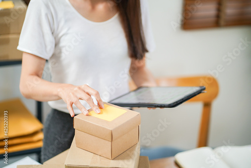 Asian woman preparing package delivery box Shipping for shopping online delivery mail service people and shipment concept © Charlie's