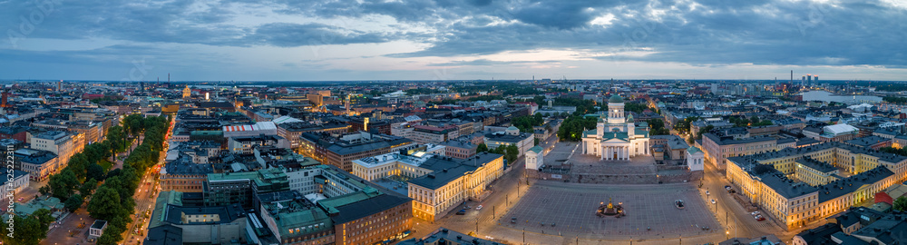Panoramic view of lit Helsinki Cathedral and city lights at dawn