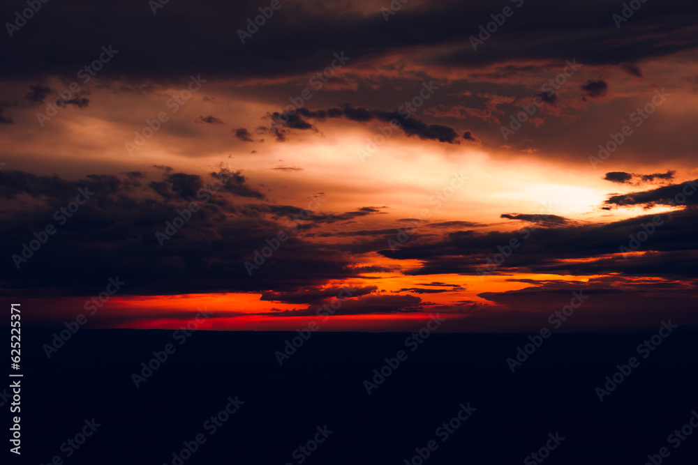 Beautiful view of the evening orange sky with black clouds Beautiful view of the evening orange sky with black clouds