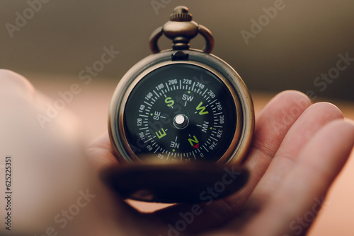 Anonymous person holding a multifunction pocket compass photo