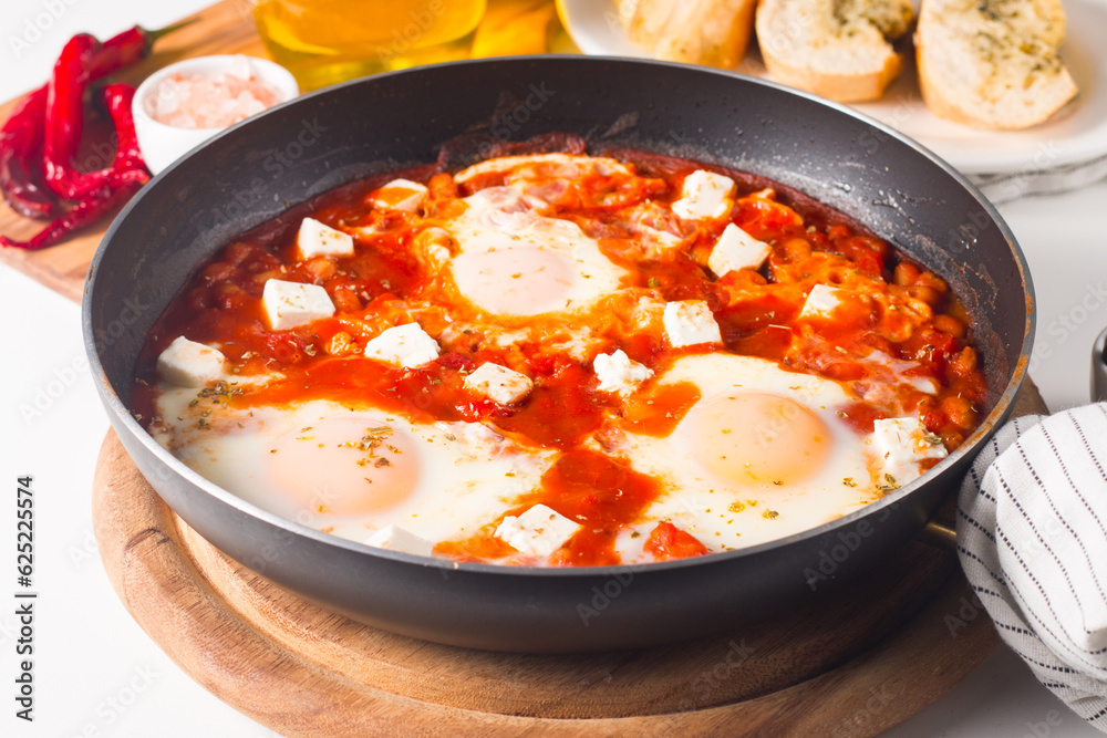 Shakshuka made of poached eggs in tomato pepper sauce Shakshuka made of poached eggs in tomato pepper sauce