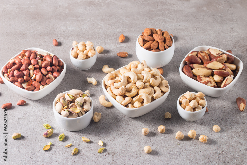 Healthy mix nuts on wooden background. Almonds, hazelnuts, cashews, peanuts, pistachios, Brazilian nuts Healthy mix nuts on wooden background. Almonds, hazelnuts, cashews, peanuts, pistachios, Brazilian nuts