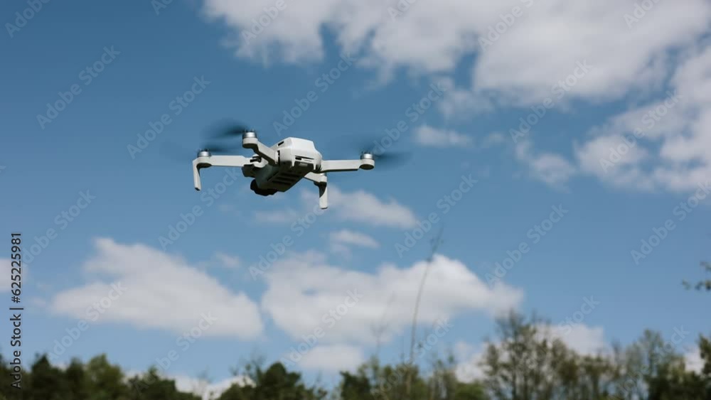 drone flying in silhouette against the blue sky, copter on a blurred background in the sunlight, slow motion drone flying in silhouette against the blue sky, copter on a blurred background in the sunlight, slow motion