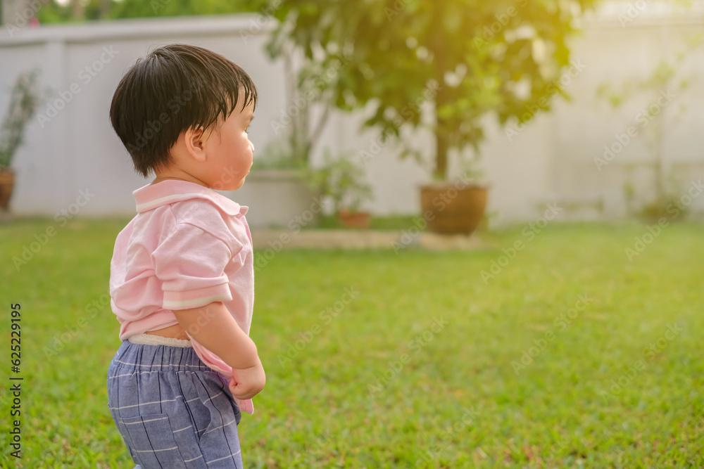 Close up portrait of asian baby sweating on face playing in the home garden with sunset. Joyful and healthy child Close up portrait of asian baby sweating on face playing in the home garden with sunset. Joyful and healthy child
