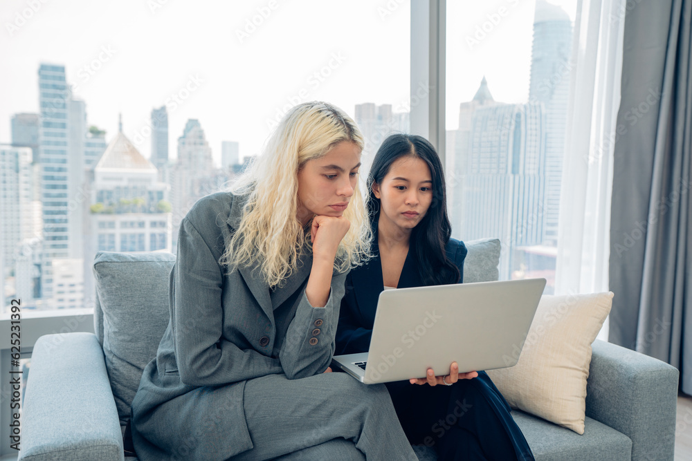 Happy business people video calling their associates on a laptop Happy business people video calling their associates on a laptop