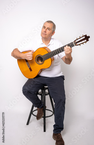 Full length portrait of Adult man playing guitar isolated on white background