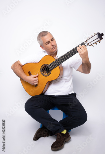 young adult man playing guitar isolated on white background