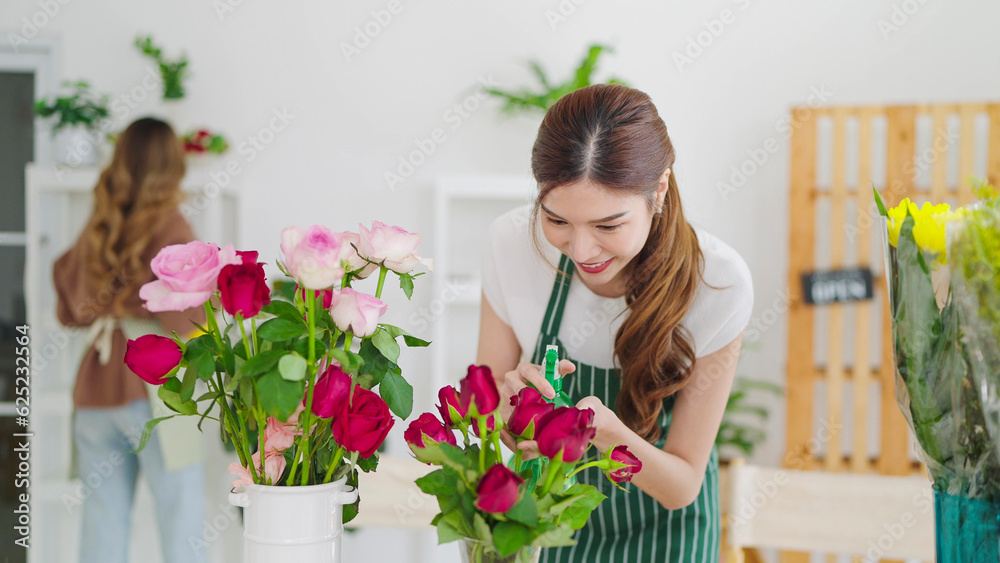 Beautiful asian woman florist working with flowers in flower shop. Woman owned of flower shop cutting flowers making bouquet for selling and delivery order to the clients. Florist concept Beautiful asian woman florist working with flowers in flower shop. Woman owned of flower shop cutting flowers making bouquet for selling and delivery order to the clients. Florist concept