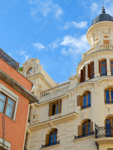 Classical residential buildings in baroque architectural style of beige colour downtown Madrid, Spain. Spanish vintage architecture. Old fashioned living