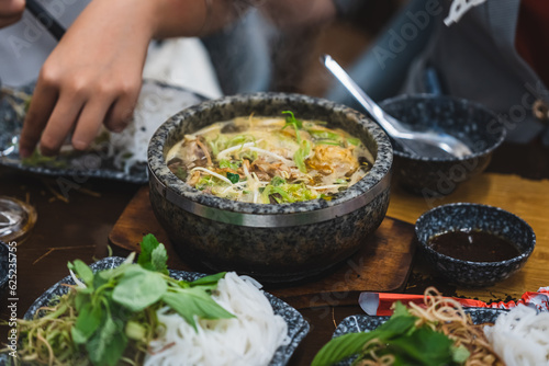Bun Bo Hue, Bun Bo, Vietnamese beef noodle soup spicy in stone bowl