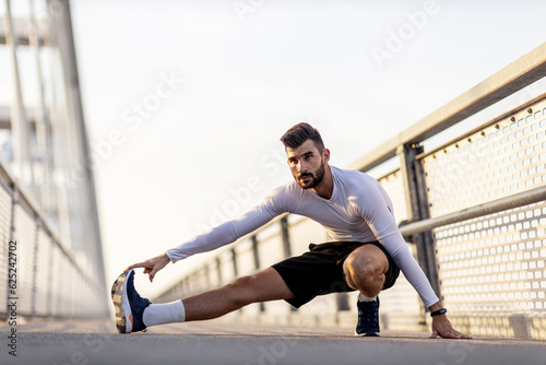 Athletic man stretch and exercise on the brigde