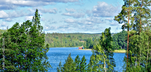summery view across the lake Gissen with bath hut near Vimmerby in the region Kalmar Län (Smaland), Sweden