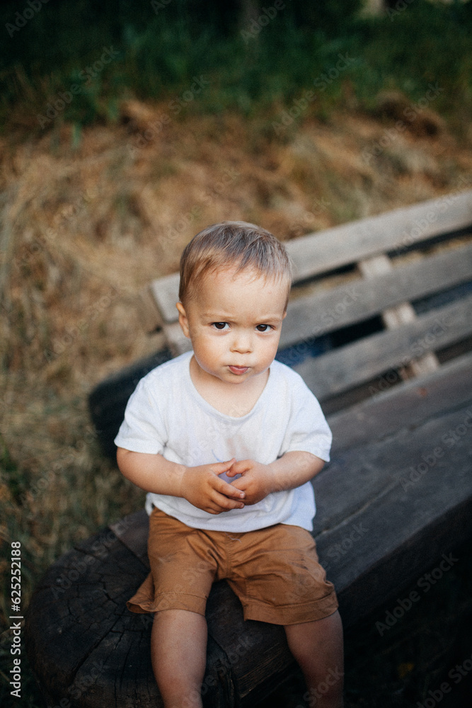 little child sitting on a bench little child sitting on a bench