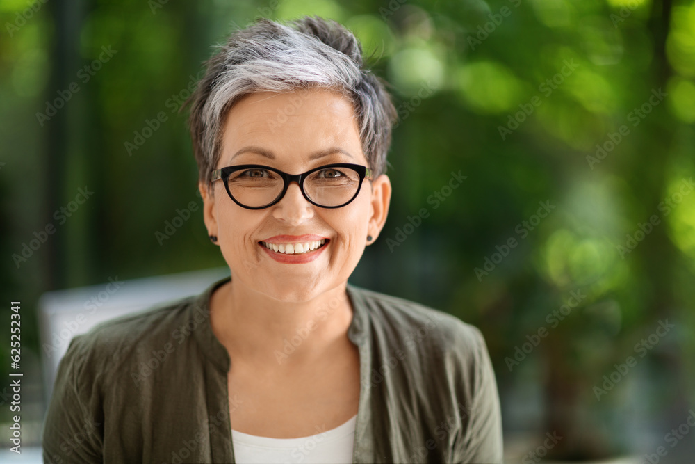 Portrait of happy middle aged businesswoman posing at office Portrait of happy middle aged businesswoman posing at office