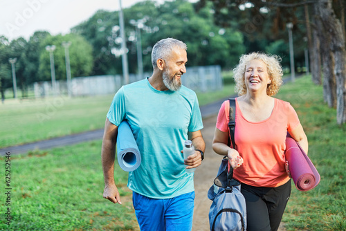 woman man couple happy mature together active fit fitness park outdoor healthy talking leisure park love old nature bonding middle aged exercise mat yoga pilates