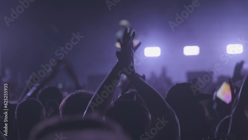 Fans clapping during live music concert photo