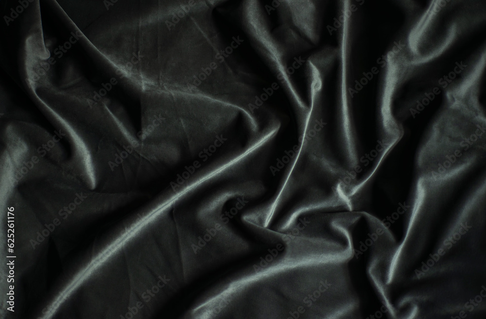 Black velvet with folds, luxury silk fabric background