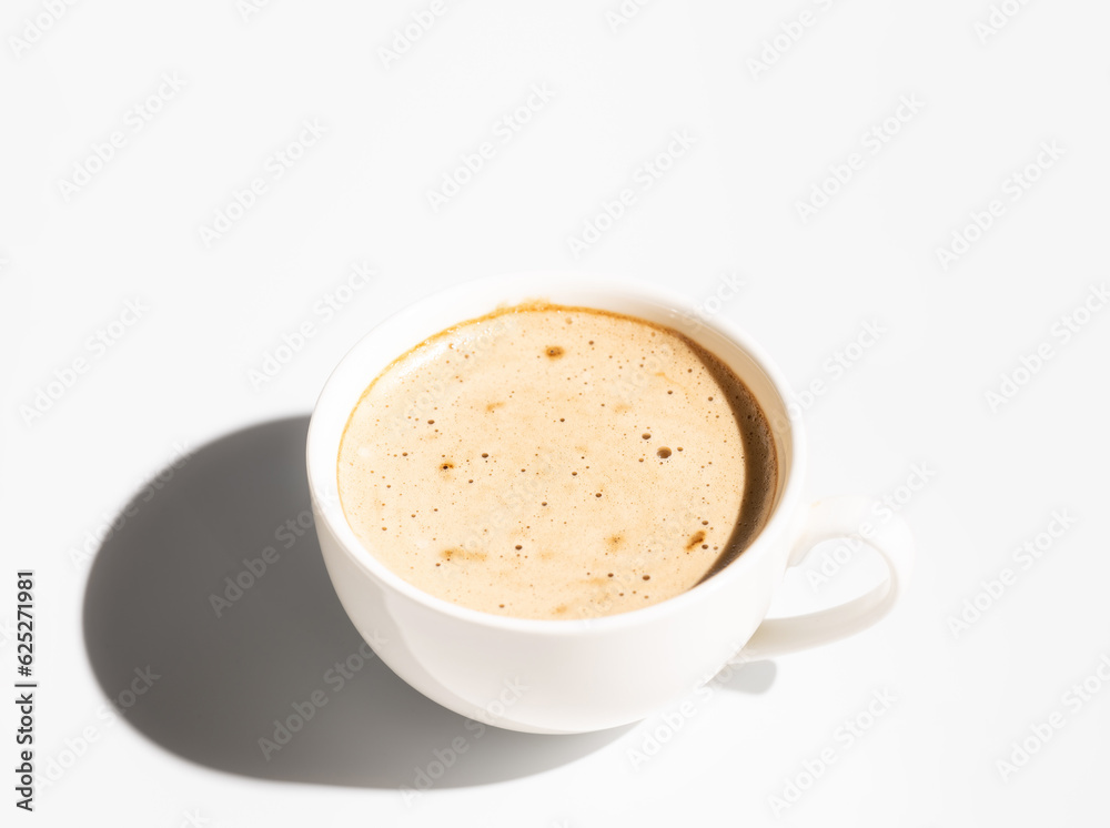 Side view of White Cup of cappuccino with creamy foam on white background. Copy space. Hard light Side view of White Cup of cappuccino with creamy foam on white background. Copy space. Hard light