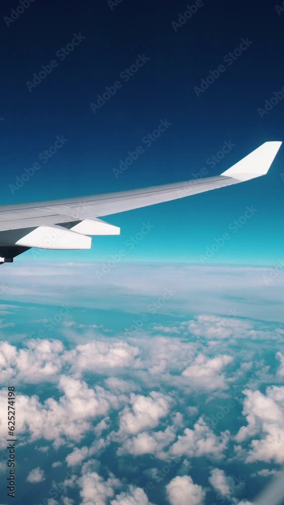 Airplane flight. Wing of an airplane flying above the clouds. . Side ...