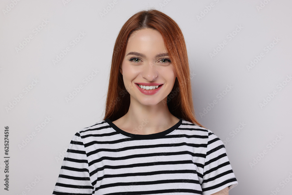 Portrait of beautiful young woman on light gray background Portrait of beautiful young woman on light gray background