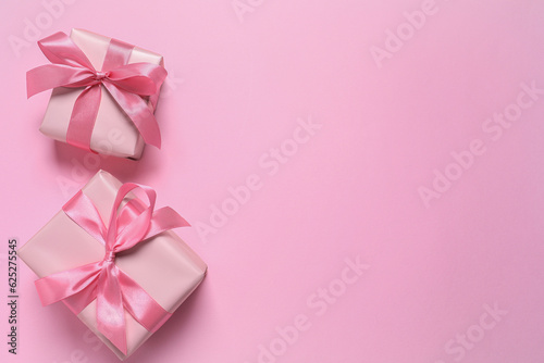 Beautiful gift boxes on pink background, flat lay. Space for text © New Africa