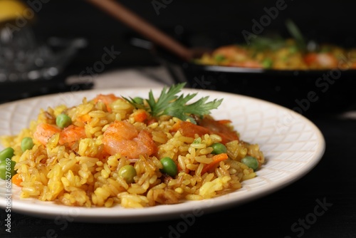 Tasty rice with shrimps and vegetables on table, closeup
