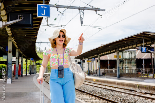 Happy young woman at train station