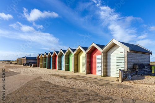 Line of colourful British beach huts at Blythe, Northumberland on the Northumbria Coast. photo