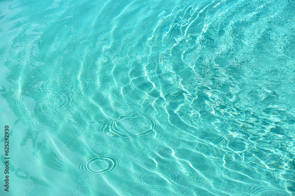 Teal blue water ripples in pool