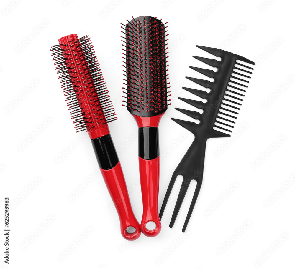 Plastic hair brushes and comb isolated on white, top view Plastic hair brushes and comb isolated on white, top view