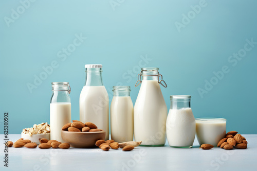 Non dairy plant based milk in bottles and ingredients on turquoise background. AI generated