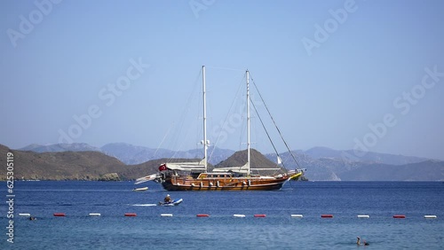 Typical Turkish style gulet yacht sailing into shallow bay. Datca resort 70 km away from Marmaris and reachable by ferryboat from Bodrum or you can reach these destinations by driving yourself or taki