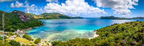 Praslin Seychelles tropical island with withe beaches and palm trees. Aerial view of tropical paradise bay with granite stones and turquoise crystal clear waters of Indian Ocean
