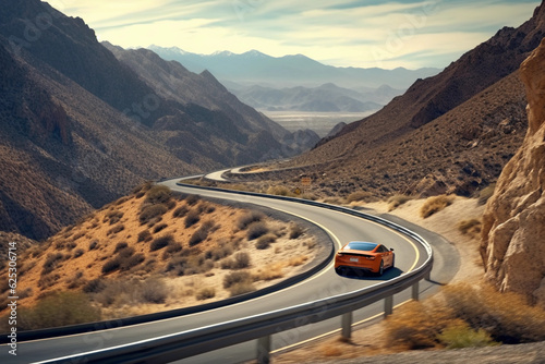 A sports car drives down a long winding road