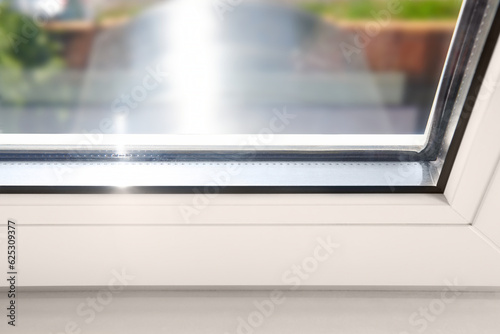 Bottom detail of window frame of PVC profiles. Window frame glass. Energy efficient, safety window glazed. Rubber seal gasket.