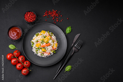 Delicious fresh white boiled rice with vegetables carrots, peppers and asparagus beans on a ceramic plate