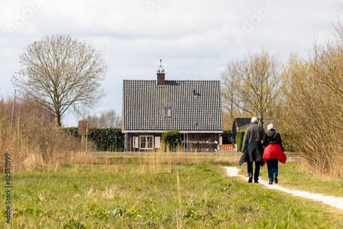 Bilde på lerret Abcoude, The Netherlands 4-1-2020: Elderly couple walks on a path in nature in t