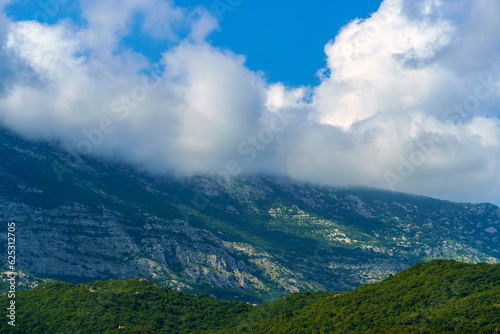 beautiful mountains and cloudy sky, summer landscape, clouds, forest on the hillsides