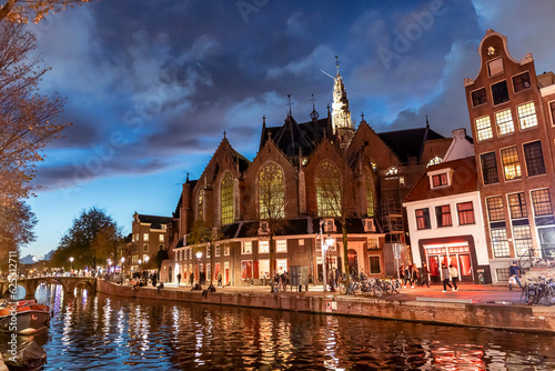 The Oude Kerk in the center of Amsterdam, Netherlands at night photo