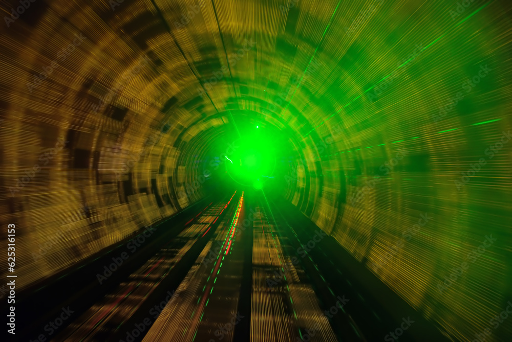 A frontal view from a subway driving in a green illuminated tunnel A frontal view from a subway driving in a green illuminated tunnel