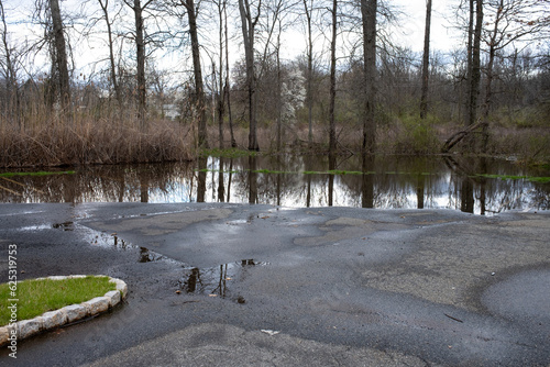 flooding in a countryside parking lot at the beginning of spring