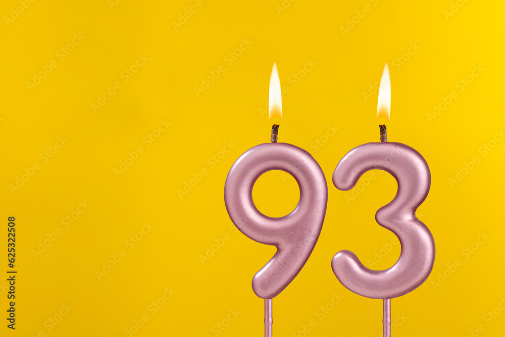 Candle 93 with flame - Birthday card on yellow luxury background Candle 93 with flame - Birthday card on yellow luxury background
